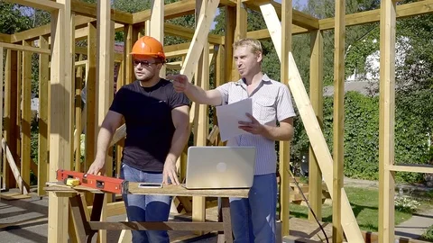 Male construction worker talking to the client on the site. Stock Footage 93519374