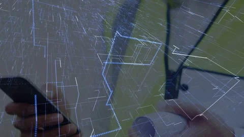 Male construction worker tapping phone and rotating sensor, summoning data lines Stock Footage 333575157