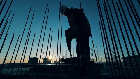 Male constructor is using a jackhammer to break concrete Stock-Footage 128303830