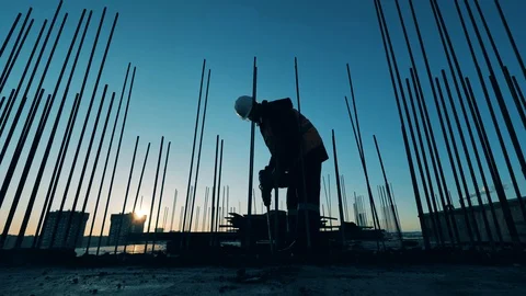 Male constructor is using a jackhammer to demolish concrete Video stock 129383498