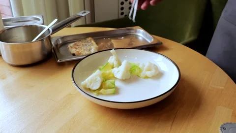 The male cook prepares the composition of the dish to be served. The cook is 스톡 동영상 265257499