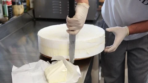 A male cook preparing the basis for the wedding cake and spreading som.. Stock Footage 72272829