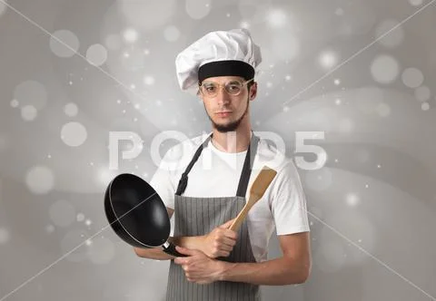 Male cook with shiny grey wallpaper Stock Photos