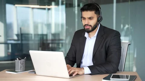 Male corporate operator in headset and suit working in customer support service  스톡 동영상 334861317