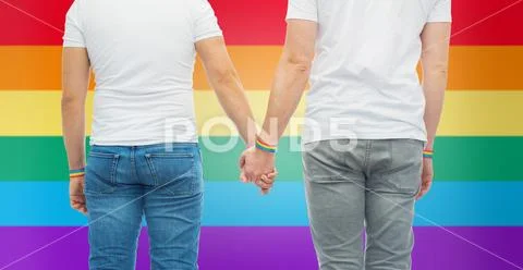 Male couple with gay pride rainbow wristbands Stock Photos