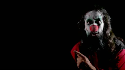 Male creepy clown in front of black Stock Footage
