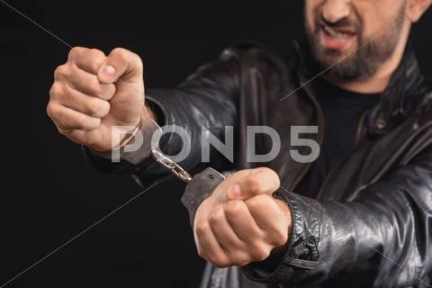 Male criminal getting rid of handcuffs Stock Photos