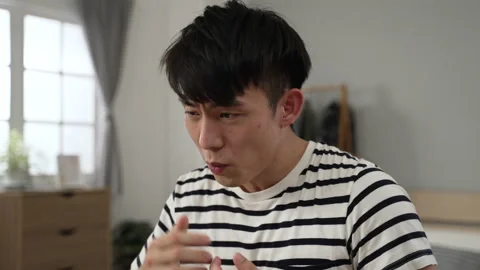 Male is cursing while grabbing his hair Stock Footage 220434396