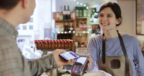 Male Customer Making Contactless Payment For Shopping Using Mobile Phone Stock Footage
