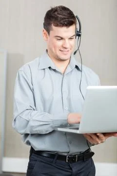 Male Customer Service Representative Using Laptop 스톡 사진