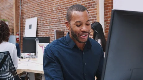 Male Customer Services Agent Working At Desk In Call Center Stock Footage 111924661