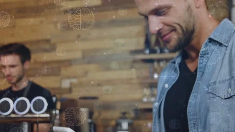 Male customer tapping tablet at cafe counter, causing animated menu and pastry 動画素材 333594612