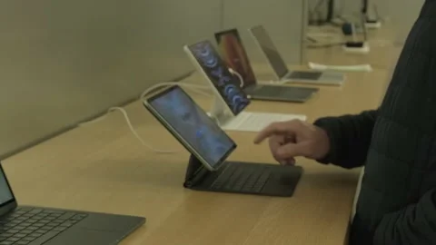 Male customer testing new tablet in apple sales office in Germany, products.. Stock Footage 224897282