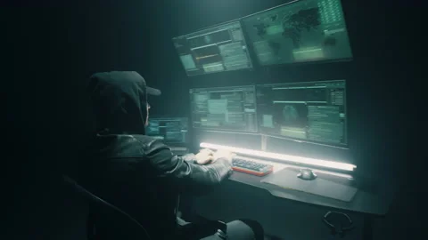 Male cyber criminal using computer under spotlight Stock Footage 170228674