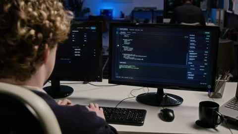 Male Cybersecurity Analyst Typing Code on Computer in Office Video stock 347290429