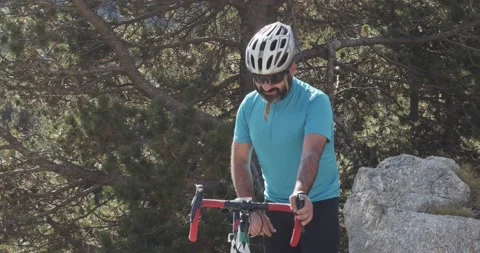 Male cyclist looking at the cycle computer of his road bike Stock Footage 140902057