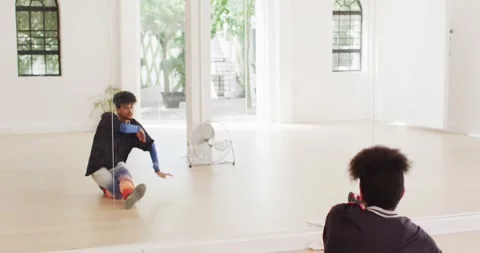 Male dancer dancing alone in front of mirror in dance studio, slow motion Stock Footage 344332951