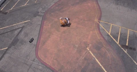Male dancer performing his routine on top of a parking garage 스톡 동영상 97015323