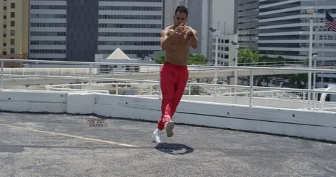 Male dancer performing his routine on top of a parking garage Stock Footage 97026587