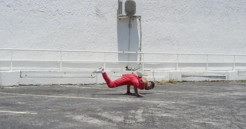 Male dancer performing his routine on top of a parking garage Stock Footage 97032163