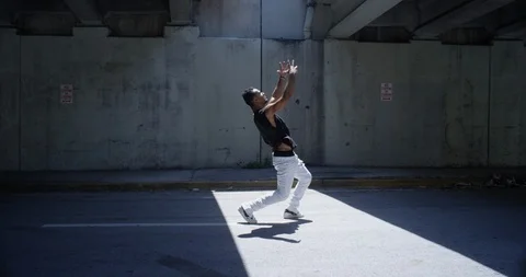 Male dancer performing his routine under an overpass Stock Footage 97033126