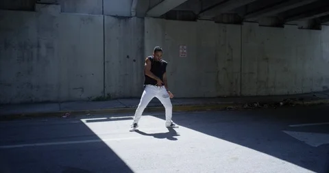 Male dancer performing his routine under an overpass Stock Footage 97037331