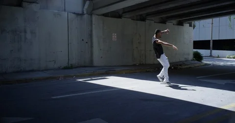 Male dancer performing his routine under an overpass Stock Footage 97038028
