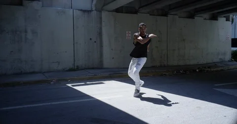Male dancer performing his routine under an overpass Stock Footage 97044465