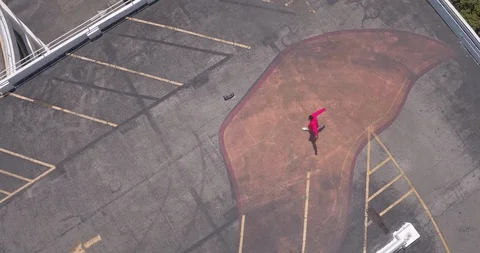 Male dancer performing his routine on top of a parking garage Stock Footage 97234286