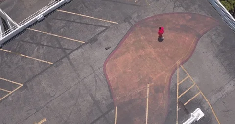 Male dancer performing his routine on top of a parking garage Stock Footage 97234737