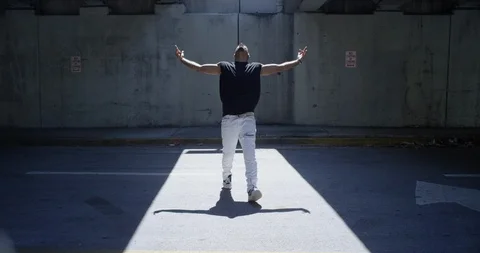 Male dancer performing his routine under an overpass Stock Footage 97237956