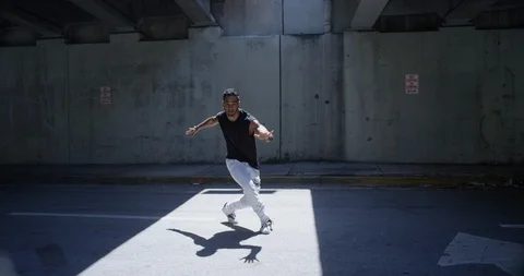 Male dancer performing his routine under an overpass Stock Footage 97238696