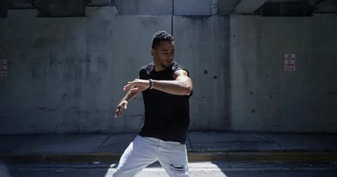 Male dancer performing his routine under an overpass Stock Footage 97244648