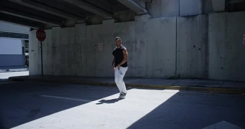 Male dancer performing his routine under an overpass Stock Footage 97390519