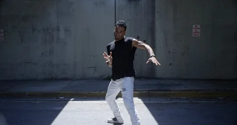 Male dancer performing his routine under an overpass Stock Footage 97447981
