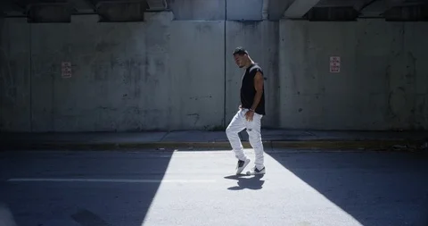 Male dancer performing his routine under an overpass Stock Footage 97450731