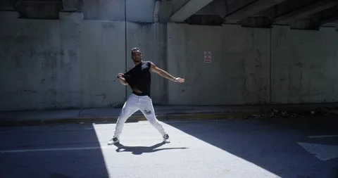 Male dancer performing his routine under an overpass Stock Footage 97454708