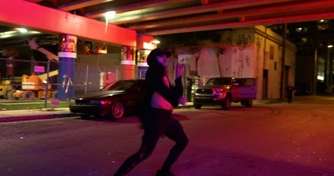 Male dancer performing his routine under an overpass at night Stock Footage 100182728