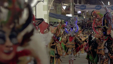 Male Dancers in Devil Masks With LED Lights at Bolivian Festival Parade - 4K Stock Footage 314455385
