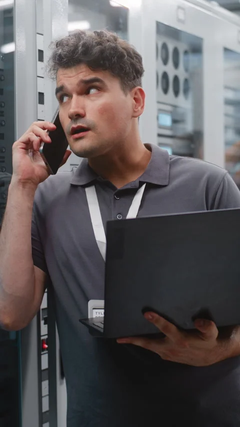 Male Data Center Engineer Reporting Server Performance by Smartphone Stock Footage 344956714