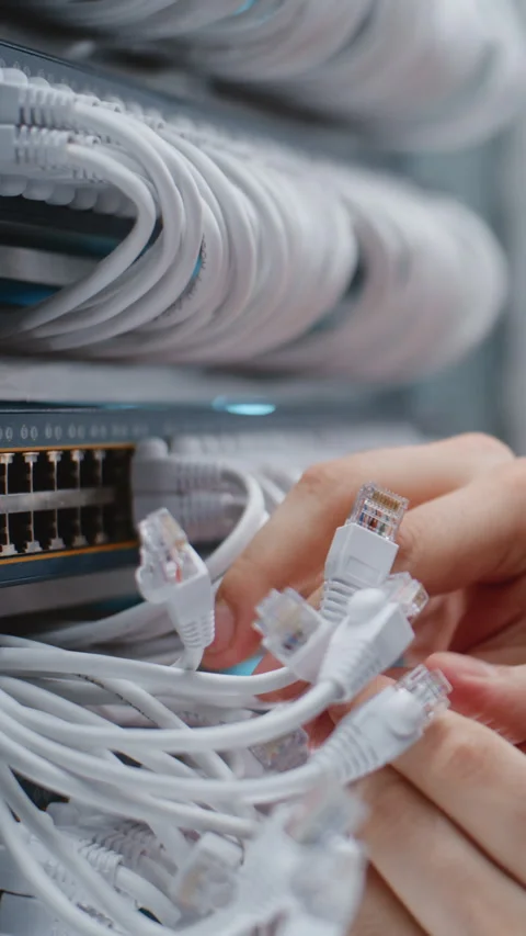Male Data Center Technician Checking Structured Cabling and Ethernet Connections Stockbeeldmateriaal 344956216
