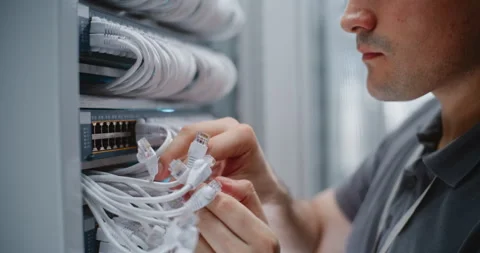 Male Data Center Technician Checking Structured Cabling and Ethernet Connections Stockbeeldmateriaal 344958612
