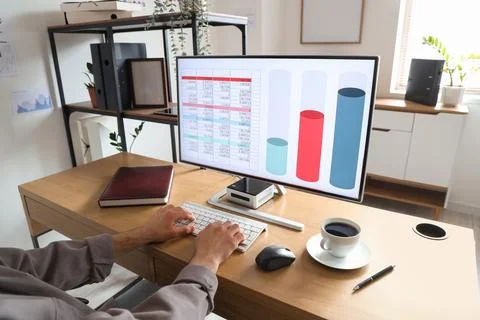 Male data scientist working with computer at desk in office Stock Photos