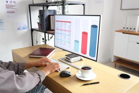 Male data scientist working with computer at desk in office 写真素材