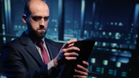 Male database admin checking hosting server on tablet Stock Footage 233221954