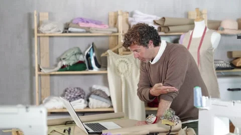 Male designer communicates with a client on a video call, he asks questions Stock Footage 323067317