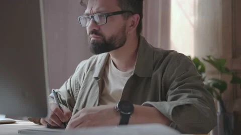 Male designer with glasses works using a graphics tablet Stock Footage 137232425