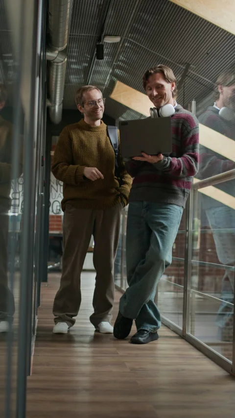 Male Developer Engaged in Conversation with His Colleague in Office Corridor Stock Footage 319998061