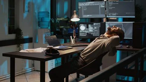 Male developer enjoying programming success at night 库存照片