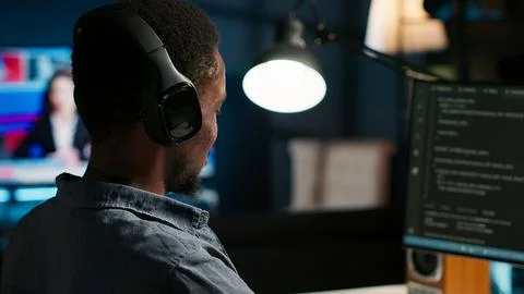 Male developer entering binary data on terminal panel while writing html code Stock Photos